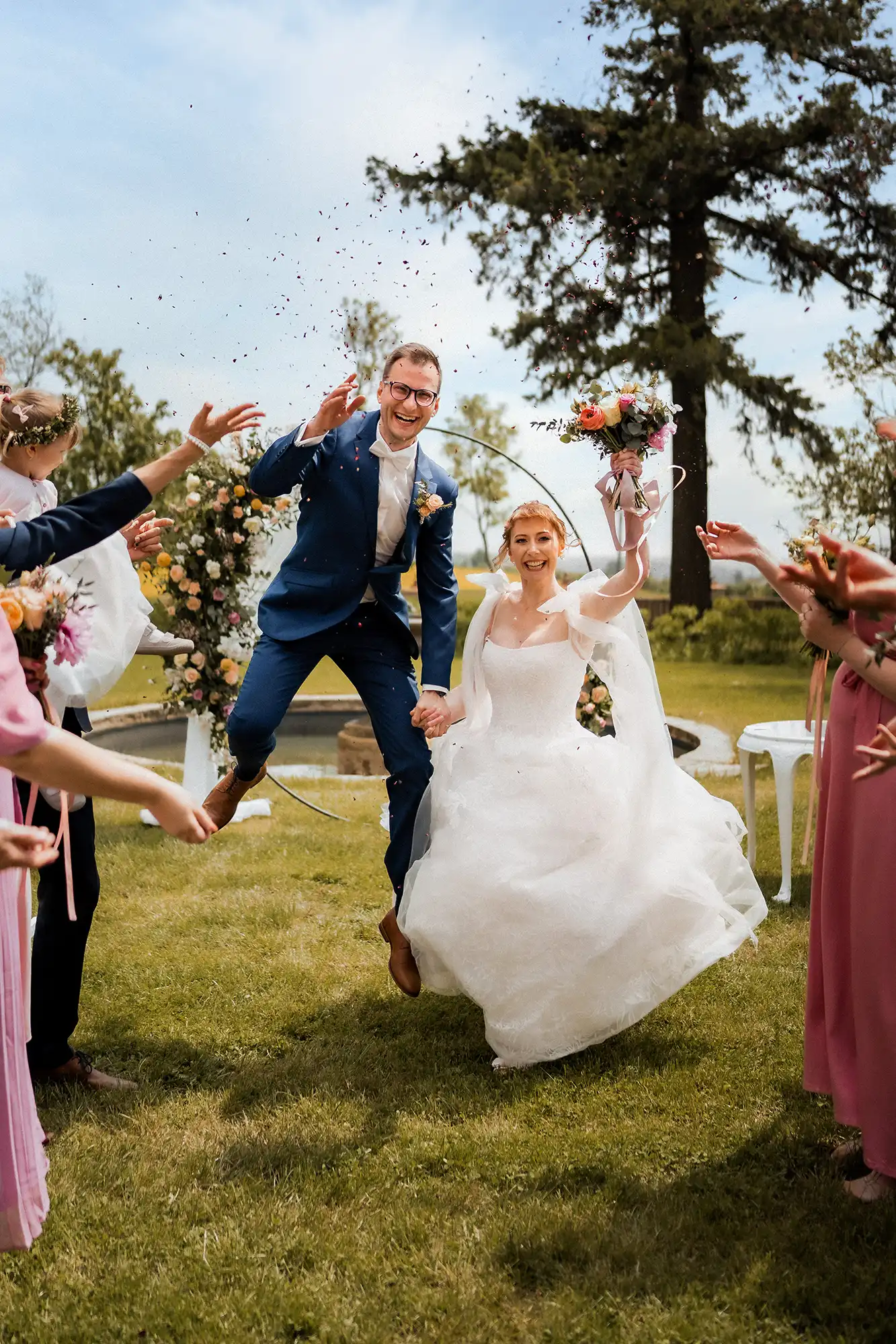 wedding photos of a jumping groom and bride in a firecracker