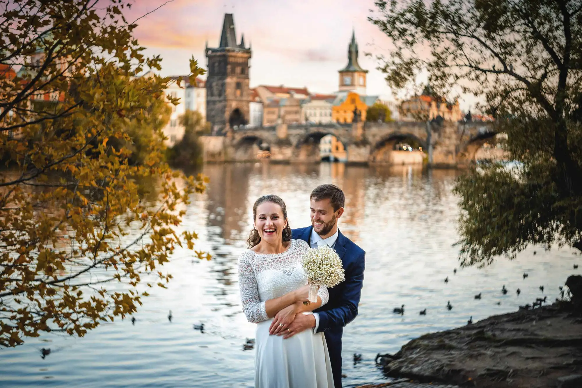 wedding photos by the Vltava River - the canal and the Charles Bridge in the background
